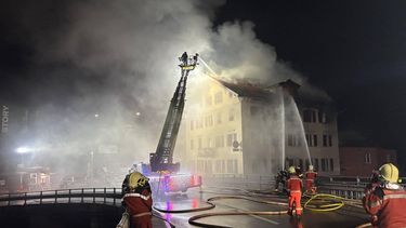 This handout photograph taken and released on August 21, 2026 by the Cantonal Police of Graubunden (Kantonspolizei Graubunden) shows a firefighters working to extinguish a fire that broke out in a building in the small town of Thusis, eastern Switzerland. A fire that broke out overnight on August 21, 2026, in a building in the small town of Thusis, in eastern Switzerland, left eight people injured and five missing, according to local police, who were alerted shortly after midnight.
Handout / Kantonspolizei Graubünden / AFP