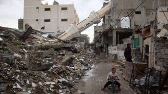 A Palestinian child rides a bicycle near a fallen minaret of a destroyed mosque during the Muslim holy fasting month of Ramadan, in the Nuseirat refugee camp in the central Gaza Strip on March 7, 2025.   
Eyad BABA / AFP
