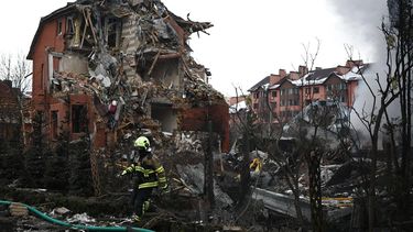 A Ukrainian rescuer walks among debris in front of a damaged house following an air attack in Sofiivska Borshchagivka, Kyiv region on February 22, 2026, amid the Russian invasion of Ukraine. Explosions rocked Ukraine's capital Kyiv with officials warning of a ballistic missile attack, just two days before the fourth anniversary of Russia's invasion.
Henry Nicholls / AFP