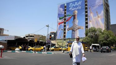 epa13029915 Iranians walk past a large-scale political billboard featuring Iranian missiles and a sword at Vanak square in Tehran, Iran, 11 June 2026. A ceasefire framework established between Washington and Tehran in April faces increasing strain following a series of US airstrikes across Iran and subsequent retaliatory missile barrages by the Islamic Revolutionary Guard Corps (IRGC) targeting US regional bases.  EPA/ABEDIN TAHERKENAREH RESTRICTIONS: NO Access Israel Media/Persian Language TV Stations Outside Iran/Strictly No Access BBC Persian/VOA Persian/Manoto TV/Iran International TV. (As mandated by Iran's Directorate General for Foreign Media) --
