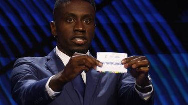 French former football player Blaise Matuidi holds up a slip of paper after drawing The Netherlands from the pot during the final draw for the UEFA Euro 2024 European Championship football competition in Hamburg, northern Germany on December 2, 2023. 
Odd ANDERSEN / AFP