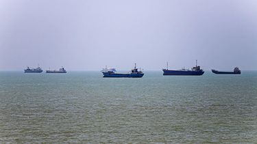 In this picture obtained from Iran's ISNA news agency on June 18, 2026, vessels are seen anchored in Bandar Abbas along the Strait of Hormuz. Oil prices tumbled after Trump and his Iranian counterpart separately signed their accord to end the Middle East war, with the Strait of Hormuz to reopen but two months of negotiations lying ahead.
AMIRHOSSEIN KHORGOOEI / ISNA / AFP