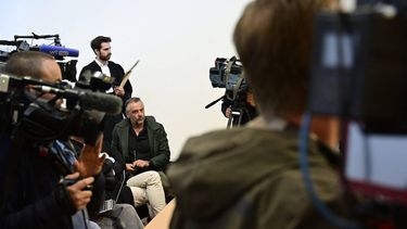 Belgian TV host Tom Waes sits surrounded by the media at the Antwerp police court, in Antwerp, on May 5, 2025.
 Waes was involved in a car accident while driving under the influence of alcohol on November 29, 2024, in which he suffered injuries and caused minor injury to a road worker.
DIRK WAEM / Belga / AFP