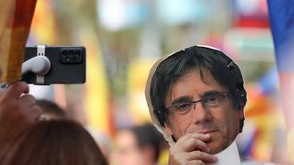 A participant holds a picture of former Catalan regional president Carles Puigdemont during the "Diada" pro-independence march on the national day of Catalonia in Barcelona, on September 11, 2025. 
Lluis GENE / AFP