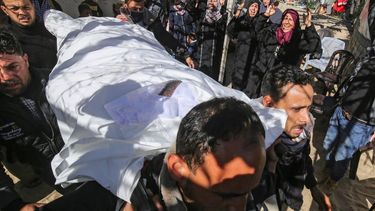 2021-03-07 15:12:11 Mourners carry the body of one of the three Palestinian fishermen, who were killed when their boat exploded off Gaza's coast in the Mediterranean Sea, during their funeral in Khan Yunis in the southern Gaza Strip, on March 7, 2021.  