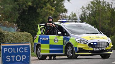 Police man a roadblock while posted outside RAF Fairford base in Fairford, south-west England on September 27, 2026, as UK counter-terrorism police investigate an incident near the base in the village of Whelford. British police on September 27 declared a major incident and evacuated villagers living near a base used by the US air force after arresting several men on suspicion of explosives offences.
JUSTIN TALLIS / AFP