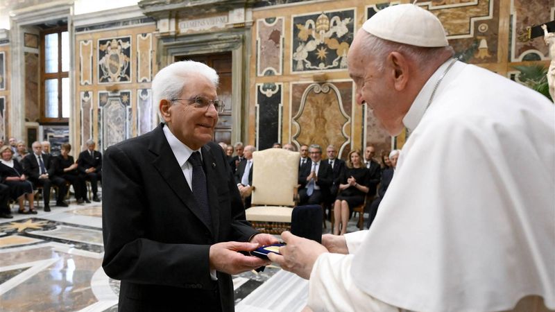 This handout photo taken and released by Vatican Media, the Vatican press office, on May 29, 2023, shows Pope Francis (R) presenting Paolo VI Prize to Italian Republic President Sergio Mattarella at the Vatican. 
VATICAN MEDIA / AFP