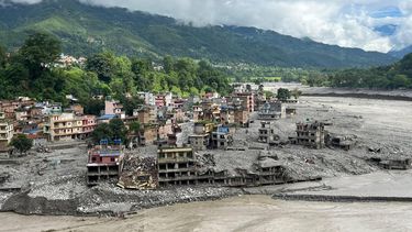 An aerial view shows a torrent of muddy water surging past houses and through the Trishuli River in the aftermath of flash floods at Trishuli Center in Nepal's Nuwakot district on September 1, 2026. Devastating floods on the China-Nepal border have killed at least 987 people in Nepal, the disaster authority said on September 1, taking overall deaths to more than 1,000.
Arun SANKAR / AFP