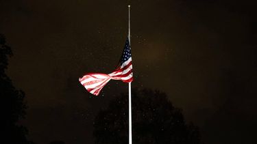 The US flag, flown half-staff to commemorate the passing of former Vice President Dick Cheney, is surrounded by leaves at the White House in Washington, DC, as President Donald Trump returns to the White House in Washington, DC, following a trip to Palm Beach with a stop at a Washington Commanders game on November 9, 2025. 
Allison ROBBERT / AFP