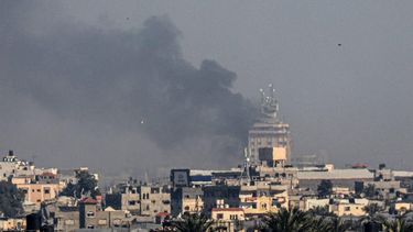 A picture taken from Rafah shows smoke billowing over Khan Yunis in the southern Gaza Strip during Israeli bombardment on December 26, 2023, amid ongoing battles between Israel and the Palestinian militant group Hamas. 
SAID KHATIB / AFP