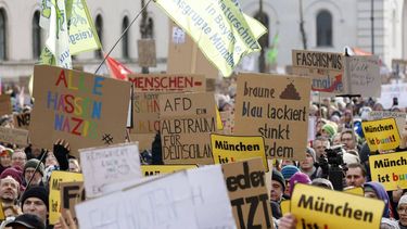 Participants hold up placards reading 'Munich is colourful' (R), 'Everyone hates Nazis' (L) and 'AfD - A nightmare for Germany' during a demonstration against racism and far-right politics in Munich, southern Germany on January 21, 2024. Tens of thousands of people were expected to turn out again on January 21 to protest against the far-right AfD, after it emerged that party members discussed mass deportation plans at a meeting of extremists.
MICHAELA STACHE / AFP