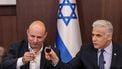 epa10191085 Israel's caretaker Prime Minister Yair Lapid (R) and former prime minister Naftali Bennett toast with small glasses of wine during the weekly cabinet meeting in Jerusalem, 18 September 2022.  EPA/RONALDO SCHEMIDT / POOL