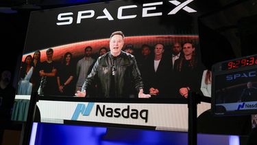 SpaceX CEO Elon Musk, displayed on a screen remotely from SpaceX headquarters in Starbase, Texas, speaks before the launch of SpaceX’s initial public offering (IPO) at the Nasdaq MarketSite in New York on June 12, 2026. Elon Musk's SpaceX begins trading on the Nasdaq exchange on Friday with the biggest initial public offering in history expected to make the polarizing entrepreneur the world's first trillionaire. The company priced more than 555 million shares at $135 each in a filing with the US markets regulator on Thursday, placing SpaceX in the top 10 of Wall Street's biggest companies with a valuation of just under $1.8 trillion -- ahead of Tesla, Facebook-owner Meta and Walmart.

TIMOTHY A. CLARY / AFP