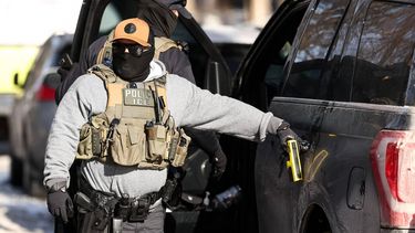 Federal agents stand by a vehicle after they detained a protester in Minneapolis, Minnesota on February 3, 2026. A US judge on January 31, 2026 denied Minnesota's bid to force Immigration and Customs Enforcement (ICE) to suspend its sweeping detention and deportation operation in the state that has left two US citizens dead and fueled massive protests. Masked and heavily armed federal agents have swept through Minnesota communities seeking undocumented migrants, detaining thousands and shooting dead two US citizens in the process.

Charly TRIBALLEAU / AFP