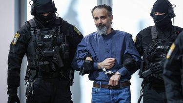 Judicial officers escort Saudi Arabian defendant Taleb Al Abdulmohsen (C) to the courtroom upon his arrival on June 26, 2026 in Magdeburg, eastern Germany, before his trial for driving an SUV through a crowd at a Christmas market. The court sentenced to life in jail the Saudi psychiatrist who drove an SUV through a crowded Christmas market in 2024, killing six people and injuring more than 300.
Ronny HARTMANN / AFP