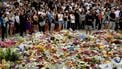 Mourners gather by floral tributes at the Bondi Pavillion in memory of the victims of a shooting at Bondi Beach, in Sydney on December 15, 2025. A father and son opened fire on a Jewish festival at Australia's Bondi Beach in a shooting spree that killed 15 people, including a child, authorities said on December 15, denouncing the attack as antisemitic 