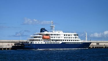 The hantavirus-stricken cruise ship MV Hondius is pictured docked in the port of Granadilla de Abona on the island of Tenerife in Spain's Canary Islands on May 11, 2026. Adverse weather conditions forced the cruise ship MV Hondius hit by a deadly hantavirus outbreak and anchored off Spain's Canary Islands to dock at Tenerife on May 11, 2026 before evacuations can be completed, the health ministry said.
JORGE GUERRERO / AFP
