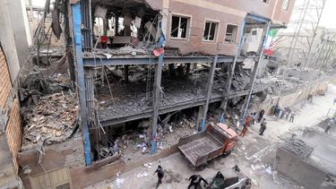 Iranian workers clear the debris from a damaged building, following a military strike on the Iranian capital Tehran on March 15, 2026. Iran's Foreign Minister said in an interview published on March 15, that the war pitting his country against the United States and Israel will only end when Tehran can be certain it will not be restarted. On February 28, Israel and the United States launched strikes on Iran, killing its supreme leader Ayatollah and triggering a war that spread across the Middle East.
Atta KENARE / AFP