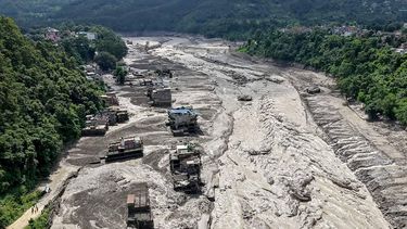 Houses lie partially submerged in muddy water along a riverside after flash floods at Trishuli Bazar in Nepal's Nuwakot district on August 26, 2026. A massive flood swept through Nepal's northern Rasuwa district on August 26, damaging roads and power infrastructure as authorities scrambled to assess the scale of the destruction.
Prabin RANABHAT / AFP