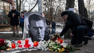 A mourner lays flowers at a makeshift memorial for late Russian opposition leader Alexei Navalny, marking the first anniversary of his death while incarcerated in a remote Arctic penal colony, in front of the Russian embassy in Prague, on February 16, 2025. 
Michal Cizek / AFP