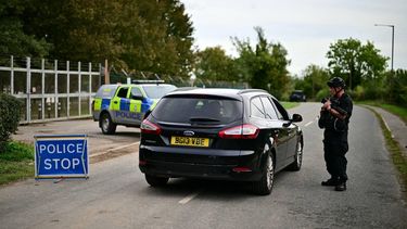An armed police officer speaks to someone in a car outside RAF Fairford base in Fairford, south-west England on September 28, 2026, a day after British counter-terrorism police were probing 