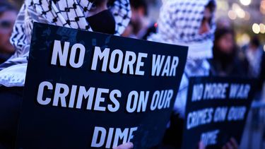 Demonstrators hold signs during a protest against US military action in Iran in the Manhattan borough of New York City on April 7, 2026. US President Donald Trump said on April 7 he agreed to suspend bombing of Iran for two weeks as part of a ceasefire deal if Tehran completely reopens the vital Strait of Hormuz. The announcement came after Pakistan made a last-minute proposal to avert massive US attacks on Iran, with Trump warning a 