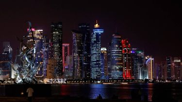 A man sits on a bench along the Corniche, looking towards at the Doha skyline on April 12, 2026. 
AFP