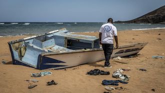 A member of the International Organization for Migration (IOM) inspects the abandoned wreckage of a boat that capsized while attempting to transport migrants to Yemen along the so-called Eastern Route at Gehere beach, near Obock, on April 12, 2026. In Djibouti, dozens of men are making the days-long trek home after their plan to cross one of the world's deadliest migration routes from Africa to the Gulf has failed.
Tens of thousands of migrants brave this so-called Eastern Route each year, most leaving from Djibouti, which lies just 30 km from Yemen at the closest point. 
More than 900 died or disappeared along the route in 2025, the deadliest year on record according to the UN International Organisation for Migration (IOM).
Luis TATO / AFP
