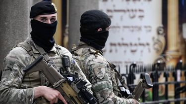 Belgian military personnel armed with FN SCAR assault rifles stand guard outside a synagogue in central Antwerp as part of Belgium's reinforced security measures established at Jewish schools and synagogues, on March 23, 2026. On March 9, 2026,an explosion shook a synagogue in the Belgian city of Liege before dawn, causing some damage but no injuries. The series of attacks on synagogues comes after the launch of the US-Israeli war on Iran, a conflict that has since broadened across the Middle East.

JOHN THYS / AFP