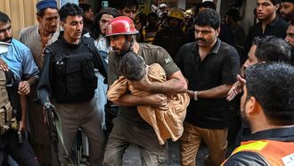 A rescuer carries a child during a search operation after a roof collapsed at a school in Peshawar on October 15, 2026. Twenty-seven pupils and a teacher were killed on October 15 after a roof collapsed at a school in the northwest Pakistani city of Peshawar, a hospital official said.
Abdul MAJEED / AFP