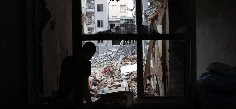 epa12821305 An Iranian person collects belongings from a damaged residential building in southern Tehran, Iran, 15 March 2026. A joint Israeli and US military operation continues to target multiple locations across Iran since the early hours of 28 February 2026.  EPA/ABEDIN TAHERKENAREH