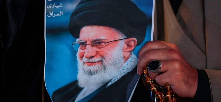 A Shiite Muslim man hold a poster of the late Iranian supreme leader Ayatollah Ali Khamenei, assassinated in a US- Israeli attack on Tehran, and a set of prayer beads during a rally in Tahrir Square, in the Baghdad on March 6, 2026.  The United States and Israel launched strikes against Iran on February 28, killing Iran's supreme leader and top military leaders, prompting authorities to retaliate with strikes on Israel and across the Gulf. Fresh strikes rocked Iran and Lebanon on March 6, as Israel and the United States stepped up their attacks in the sprawling Middle East war, with powerful explosions shattering the skies of Tehran.
Murtaja LATEEF / AFP