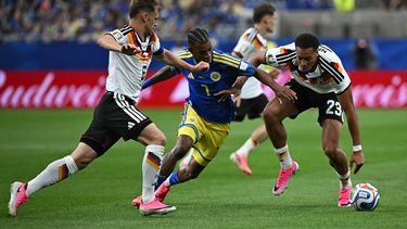 Curacao's midfielder #07 Juninho Bacuna (C) fights for the ball with Germany's defender #06 Joshua Kimmich (L) and Germany's defender #23 Felix Nmecha during the 2026 World Cup Group E football match between Germany and Curacao at the Houston Stadium in Houston on June 14, 2026. 

Paul ELLIS / AFP