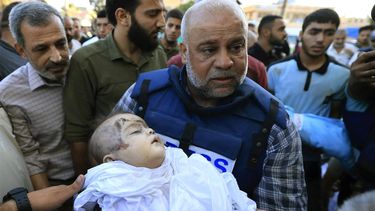 Al-Jazeera correspondent Wael Al-Dahdouh carries the shrouded body of one of his children who was killed along with his wife the day before in an Israeli strike on the Nuseirat camp, prior to being taken for burial from at Al-Aqsa hospital in Deir Al-Balah, on the southern Gaza Strip, on October 26, 2023. The family of the Al Jazeera journalist were killed in an Israeli strike on Gaza, the Qatar-based network said in a statement on October 25, as war rages between Israel and Hamas. Al Jazeera said the wife and two children of its Arabic-language channel's Gaza correspondent Wael Al-Dahdouh were killed in a strike on the Nuseirat refugee camp in the Gaza strip.
Mahmud HAMS / AFP