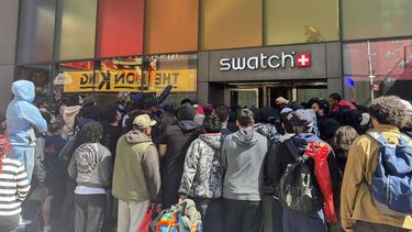 People wait in line to enter the Swatch store in Times Square in New York on May 16, 2026, ahead of the Audemars Piguet x Swatch Royal Pop watch release. The launch of limited edition Swatch watches descended into chaos Saturday in several European cities and New York, with French police firing tear gas to restore order at one store near Paris. Hundreds of people waited through the night -- and in some cases for several days -- hoping to get their hands on the 