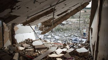 A man checks the ruins of a house after an Israeli air raid in Majdal Zoun on December 17, 2023, amid increasing cross-border tensions as fighting continues with Hamas militants in the southern Gaza Strip. 
Hassan FNEICH / AFP