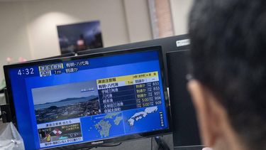 Reporters watch the news showing a large quake and possible one meter tsunami wave in Southern Japan, from an office in Tokyo on July 28, 2026.  A strong 7.1-magnitude earthquake hit southern Japan, the Japan Meteorological Agency said, issuing a tsunami alert. The tremor also measured at the highest possible level seven on Japan's own Shindo scale of shaking, the agency said.
Andrew CABALLERO-REYNOLDS / AFP