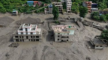 Houses lie partially submerged in muddy water along a riverside after flash floods at Trishuli Bazar in Nepal's Nuwakot district on August 26, 2026. A massive flood swept through Nepal's northern Rasuwa district on August 26, damaging roads and power infrastructure as authorities scrambled to assess the scale of the destruction.
Prabin RANABHAT / AFP
