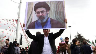 epa12726144 An Iranian man holds a picture of Mojtaba Khamenei, the son of the Iranian Supreme Leader, as he takes part in celebrations of the 47th anniversary of the Islamic Revolution in Tehran, Iran, 11 February 2026. The Islamic Republic marks the anniversary of the 1979 revolution, which toppled the monarchy and established the Islamic Republic of Iran, with Ayatollah Ruhollah Khomeini serving as its first Supreme Leader.  EPA/ABEDIN TAHERKENAREH