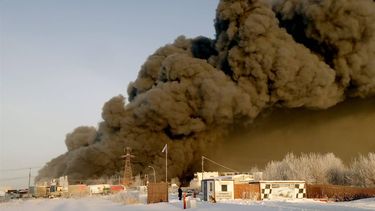 epa11073102 Smoke rises from a fire at a burning warehouse of the Russian Internet store Wildberries in Shushary, outside St. Petersburg, Russia, 13 January 2024. According to the Ministry of Emergency Situations, the fire area was 5.000 square meters. 270 people and 57 pieces of equipment are involved in extinguishing the fire. As reported by Wildberries, people who were in the warehouse were evacuated. Sellers and buyers will receive compensation for damaged or lost items, the company announced.  EPA/ANATOLY MALTSEV