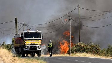 A French Civil Security firefighter walks on a road next to a wildfire near Ille-sur-Têt, southern France, on July 5, 2026. A wildfire broke out on July 4 at around 19h30 (1730 GMT) in a hard-to-reach massif near Trevillach, in the Pyrenees-Orientales department of southern France and spread rapidly overnight, burning through nearly 1,000 hectares by the morning of July 5, but the fire is no longer spreading freely, according to the prefecture. More than 580 firefighters have been deployed on the ground to fight the blaze.
Matthieu RONDEL / AFP