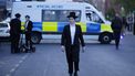 epa12922349 A member of the Jewish community walks in front of a police van near the scene where two Jewish men were seriously injured after being stabbed in Golders Green, north London, Britain, 29 April 2026. The Metropolitan Police said the incident is being treated as a terrorist incident, with officers investigating whether the attack deliberately targeted the Jewish community.  EPA/TOLGA AKMEN