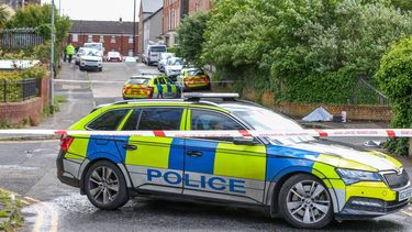 Police work at the scene of a stabbing on Kinnaird Avenue in north Belfast, Northern Ireland, on June 9, 2026.  Northern Ireland police said Tuesday they had arrested a man following a 