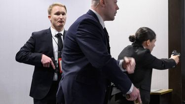 Agents draw their guns after loud bangs were heard during the White House Correspondents' dinner at the Washington Hilton in Washington, DC, on April 25, 2026. US Secret Service agents bundled Donald Trump from the stage as shots rang out Saturday evening at a media gala, in what the president later described as an attack by a 