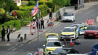 Items, including clothes and trainers, are pictured strewn in the road in front of a Police car (R), inside a Police cordon on Golders Green Road, in the Golders Green neighbourhood of north London, on April 29, 2026, after two people were stabbed, and a suspect arrested. Two people were stabbed on April 29 in north London, Jewish groups said, following a series of arson attacks targeting Jewish sites in the area. A man was arrested after he was seen running with a knife 