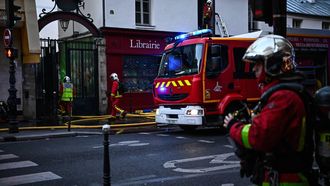 Firefighters work to extinguish a fire at «Le marche des Enfants Rouges» (Red Children market) center of Paris on October 12, 2026. 
JULIEN DE ROSA / AFP