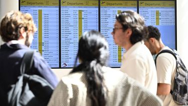 Passengers look at an information board indicating cancelled and delayed flights, as Belgian air traffic control organisation Skeyes is on strike, at Brussels Airport in Zaventem on June 2 2026. 
JASPER JACOBS / Belga / AFP