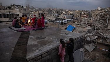 epaselect epa11807841 Amr Abu Hashem (C), a 26-year-old displaced Palestinian from Khan Younis, sits with a Palestinian family on the roof of their destroyed house as he dressed as Santa Claus to tour the destroyed homes and temporary tent shelters of displaced families in Khan Younis, Gaza Strip, distributing candy and entertaining children, 05 January 2025. Omar, who lost a leg during one of the wars in the Gaza Strip, says he took this initiative to bring some joy to displaced children ahead of the Eastern Christmas celebrations despite the difficult circumstances. More than 45,300 Palestinians and over 1,400 Israelis have been killed, according to the Palestinian Health Ministry and the Israeli Army, since Hamas militants launched an attack against Israel from the Gaza Strip on 07 October 2023, and the Israeli operations in Gaza and the West Bank which followed it.  EPA/HAITHAM IMAD  ATTENTION: This Image is part of a PHOTO SET