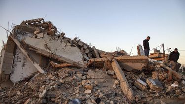 Men check the ruins of a house after an Israeli air raid in Majdal Zoun on December 17, 2023, amid increasing cross-border tensions as fighting continues with Hamas militants in the southern Gaza Strip. 
Hassan FNEICH / AFP