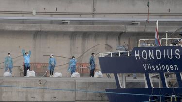 Persons with protective suits wait in line after disembarking from the hantavirus-stricken cruise ship MV Hondius docked in the port of Granadilla de Abona on the island of Tenerife in Spain's Canary Islands on May 11, 2026. Adverse weather conditions forced the cruise ship MV Hondius hit by a deadly hantavirus outbreak and anchored off Spain's Canary Islands to dock at Tenerife on May 11, 2026 before evacuations can be completed, the health ministry said.
JORGE GUERRERO / AFP